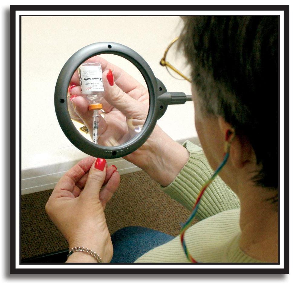 photo of woman reading bottle using a magnifying glass